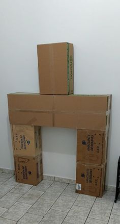 two boxes stacked on top of each other in front of a fire place with a chair