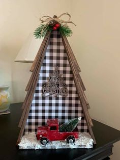 a wooden christmas tree with a red truck