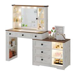 a white desk with drawers and a mirror on top of it next to a shelf