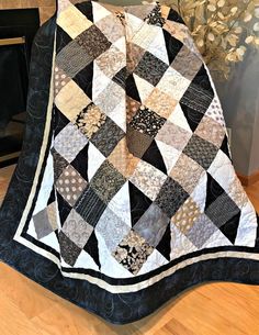 a black and white quilt on the floor