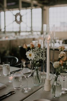 the table is set with flowers and wine glasses