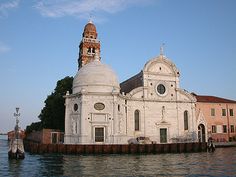 a large white building sitting on top of a body of water