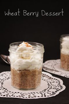 two small jars filled with food on top of doily