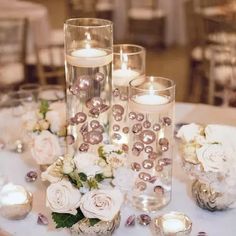 the centerpieces are filled with candles and flowers