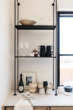 the shelves are filled with bottles, cups and other items on top of each shelf