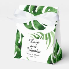 a green and white box with a ribbon tied around the top that says love and thanks