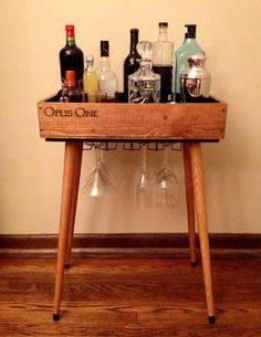 a wooden table with wine glasses and bottles on it