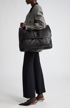 This extralarge lambskin version of a signature shoulder bag still retains its defining design elements, such as the gusseted front pocket and YSL insignia. Dual compartments with a zip divider and pull-through strap with leather shoulder rests enhance its everyday functionality. 18"W x 14 3/4"H x 6 1/4"D. (Interior capacity: extra-large.) 12 3/4"strap drop 3.89lb Magnetic flap closure Pull-through chain-and-leather strap Exterior gusseted pocket under flap; back slip pocket Dual interior compar Ysl Handbags, Handbag Straps, Large Bag, Green Bag, Ysl Bag, Front Pocket, Leather Shoulder Bag, Design Elements, Leather Straps