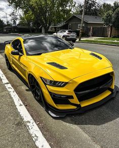 a yellow car parked on the side of the road