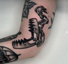 a person with a tattoo on their arm holding an umbrella and chain attached to it