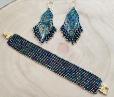 Iris blue beacelet and earrings  In this set I beaded thousands of iris blue cylinder beads and seedbeads. The design is simple but because of the color palette of the beads the result is so sparkly and eyecatching. The bracelet was beaded with The flat herringbone technique. The beacelet is 18 cms long a 3 cms wide, closes with a beautiful gold color magnetic watch clasp. The earrings are 10 cms long, so light and have gold plated stainless steel earwires. The upper part was created with bricks Magnetic Watch, Watch Clasp, Wedding Jewelry Sets, Blue Bracelet, Earrings Set, Hungary, Arm Band, Jewelry Set, Earring Set