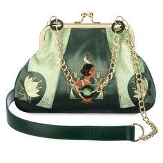 You'll know you're almost there when carrying this elegant satin handbag with vintage art deco styling. It features Tiana, lotus flowers, golden detailing and hardware, including a chunky link chain handle and a detachable shoulder strap. It's a perfect piece to set off your evening ensemble or dress up that everyday casual look. Black Disney Princess, Disney Lifestyle, Disney Princess Tiana, Disney Purse, Dooney And Bourke Disney, Disney Dooney, Disney Handbags, Princess Tiana, Princess And The Frog