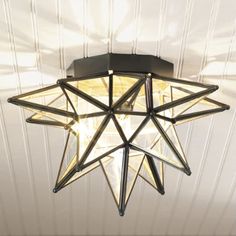 a star shaped light fixture hanging from the ceiling