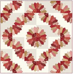 a red and white quilt with many different designs on it's sides, including the center