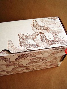 an open box with some butterflies on it