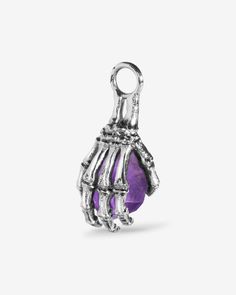 A beckoning from the beyond enticing all covetous eyes with its grasped umbral crystal. A charm of a skeletal hand gripping an amethyst. 360° designs with details all-round. Each charm comes with a complimentary charm clasp for easy attachment to any base jewelry. Compatible with any base jewelry of your choice from The Charm Lab series. Collect charms and design your own collection that tells your story. Complete your look with other jewelry from the Reaper series. Sold individually. Each piece Halloween Claw-shaped Jewelry Gift, Halloween Jewelry Gift With Claw Shape, Halloween Gift Jewelry With Claw Shape, Gothic Sterling Silver Jewelry With Lobster Clasp, Halloween Silver Claw Jewelry, Gothic Purple Metal Jewelry, Purple Gemstone Metal Jewelry, Gothic Claw Shaped Jewelry Gift, Gothic Claw Jewelry Gift