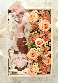 a bottle of wine and flowers in a box