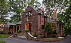 a brick house with stone steps leading up to the front door and windows on each side