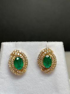 These earrings are so pretty! A cluster of full cut round brilliant diamonds surrounds each of these oval shaped emeralds for a classic, elegant look.  The emeralds are natural earth mined gems. Each oval shaped emerald measures approximately 7.5mm X 4.0 mm . The approximate weight is 1/2 ct each.  There are 50 diamonds in each earring for a grand total of 100 diamonds and an approximate total weight of 1/2 carat. All diamonds are H-I color and SI clarity.  The earrings measure 15.24 mm long and 10.82 mm wide.  The total weight of the earrings is 3.3 grams. 14 kt Yellow gold Shipping and insurance is included in the price of the item. I ship all orders via USPS Priority Mail so you should receive your order within three days after mailing. Emerald And Diamond Earrings, Purple Sapphire Ring, Purple Sapphire, Earrings Design, Party Earrings, Emerald Earrings, Green Gemstones, Classic Elegant, Brilliant Diamond