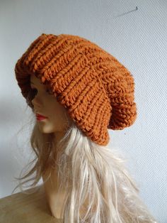 an orange knitted hat on top of a mannequin head