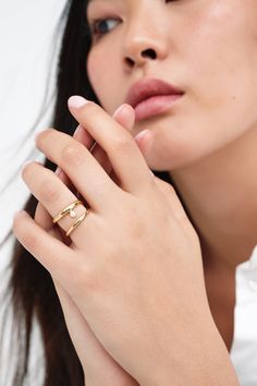 Our Mandy Abstract Ring is an emblem of elegance. Handcrafted from brass with 18k gold plating, this asymmetrical ring coils twice around your finger and presents a luminous faux pearl between her bands. Delicate and expressive, modern and timeless, Mandy raises the standard for your capsule jewelry box. Each ring includes a Marcella-branded vegan leather travel case for safe storage and easy travel.[SPLIT] Available in one size. Approximately .75” (2 cm) in height, and 1" (2.25 cm) in width. 18 Capsule Jewelry, Abstract Ring, Asymmetrical Ring, Safe Storage, Easy Travel, Leather Travel, Coils, Travel Case, Gold Plating