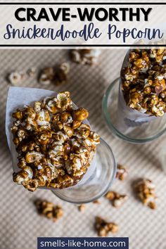 two glasses filled with caramel popcorn on top of a table