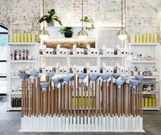 a room filled with lots of white shelves covered in bottles and vases next to each other