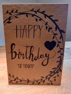 a brown card with the words happy birthday to you written in black ink on it