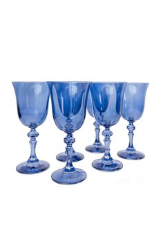 five blue glass goblets are lined up in a row