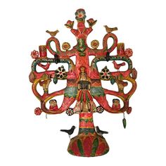 an ornately decorated clock with birds and flowers on it's face, in the shape of a tree