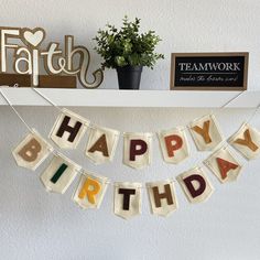 a happy birthday banner hanging from a shelf