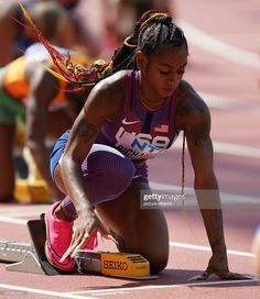 a female athlete kneeling down on the track