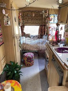 the inside of a mobile home kitchen and dining area with lots of clutter on the counter