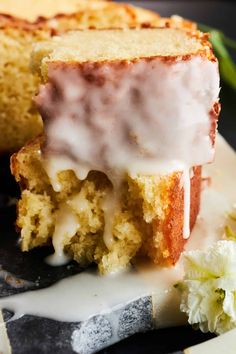 a close up of a piece of cake on a plate with flowers in the background