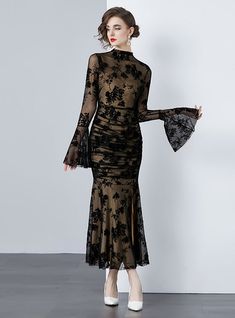 Mystique becomes tangible in this delicately crafted black lace dress that exudes both elegance and sensuality. A sheer overlay with intricate floral patterning cascades over a sleek, form-fitting underlay, creating a dance between concealment and revelation. The full-length sleeves bloom into fluted cuffs, adding a touch of dramatic flair, while the high neckline balances the ensemble with a touch of traditional grace. Perfect for gala events or sophisticated soirées, this dress demands attenti Fitted Sheer Mesh Dress For Gala, Party Mesh Dress With Sheer Lace Sleeves, Elegant Dresses With Delicate Lace For Night Out, Fitted Mesh Dress With Sheer Sleeves For Gala, Fitted Lace Patchwork Dress For Night Out, Sheer Lace Fitted Mesh Dress, Fitted Sheer Lace Mesh Dress, Fitted Sheer Mesh Evening Dress, Sheer Fitted Lace Dress For Evening