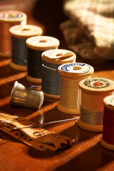 several spools of thread are sitting on a table