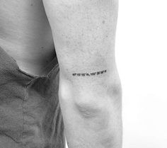 a man's arm with a small tattoo on the left side of his arm