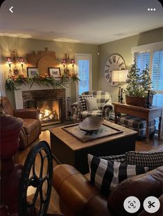 a living room filled with furniture and a fire place in front of a clock on the wall