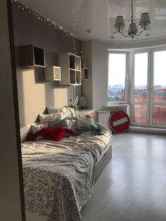 a bed room with a neatly made bed and a large window