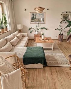 a living room filled with furniture and plants