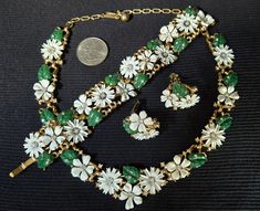 Vintage Trifari jewelry set. Green/ white enamel. Note some enamel is missing from the piece, green leaves. please observe pictures closely for details. And ask questions if you have any prior to buying. I'm good vintage condition. Signed Trifari crown White Enamel Jewelry For Formal Occasions, Formal White Enamel Jewelry, Green Enamel Jewelry For Wedding, Collectible Enamel Jewelry With Matching Earrings, Green Enamel Wedding Jewelry, Formal Green Enamel Jewelry, Green Flower-shaped Formal Jewelry, Vintage Enamel Jewelry With Matching Earrings, Vintage Trifari Jewelry