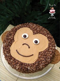 a cake that looks like a monkey face on top of some brown rice krispy kreme