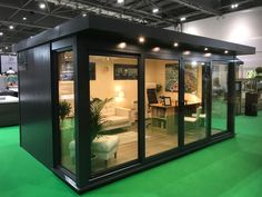 a room filled with furniture and green carpet