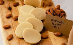 almonds and cookies on a cutting board with a sign that says homemade almond paste