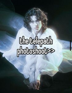 a woman sitting on the ground with her hands in her pockets and text that reads, the telepath photoshot