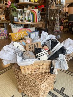 a basket filled with lots of items on top of a floor next to a rug