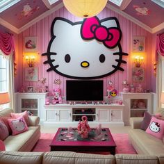 a living room decorated in pink and white with hello kitty decorations on the wall above it