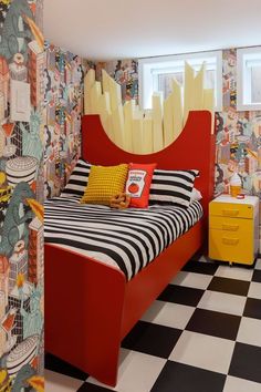 a bedroom with colorful wallpaper and black and white checkered flooring is shown