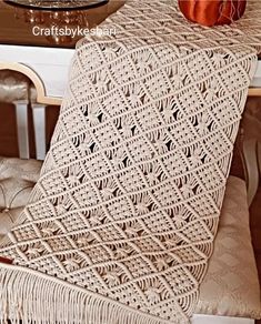 a crocheted blanket sitting on top of a chair