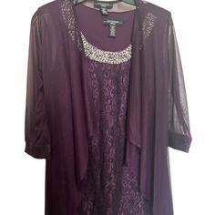 a purple dress and jacket on a hanger